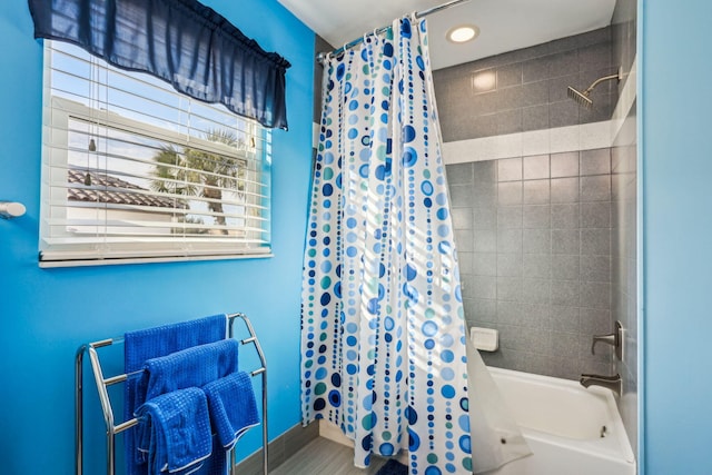 bathroom with recessed lighting, shower / bath combination with curtain, and baseboards