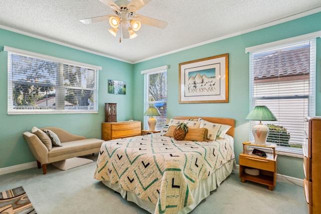 carpeted bedroom featuring crown molding, ceiling fan, and a textured ceiling