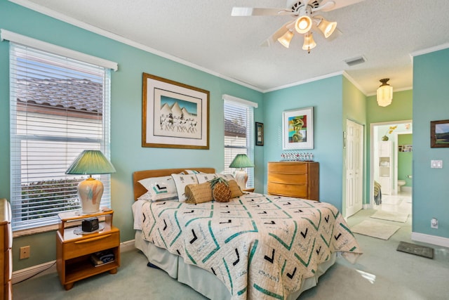 bedroom with light colored carpet, ornamental molding, ensuite bath, and a textured ceiling