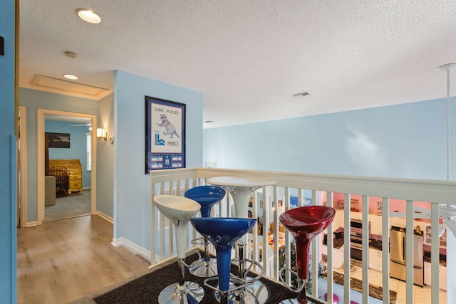 interior space featuring hardwood / wood-style flooring and a textured ceiling