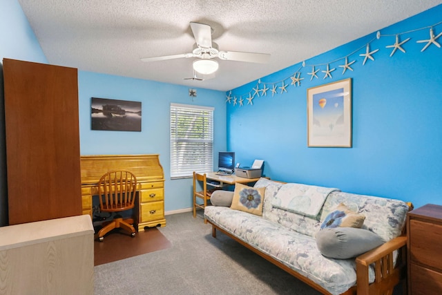 carpeted office with ceiling fan and a textured ceiling