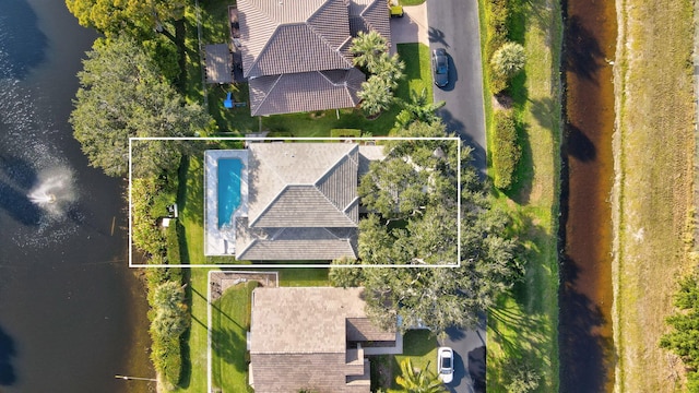 birds eye view of property with a water view