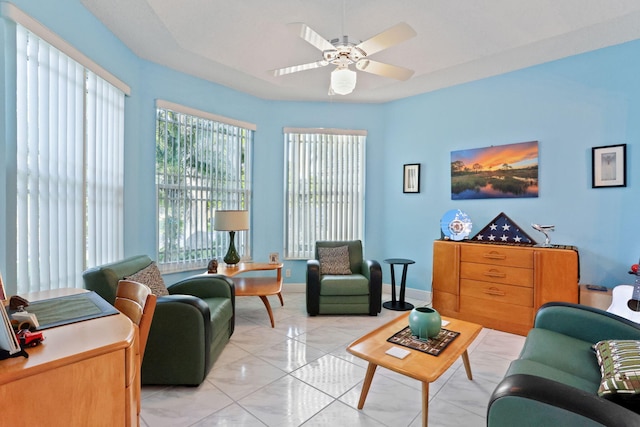 living room featuring light tile patterned floors and ceiling fan