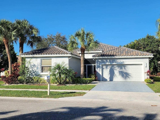 view of front of property with a garage and a front lawn