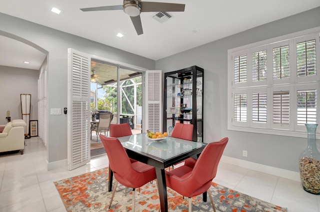 dining space featuring ceiling fan and light tile patterned floors