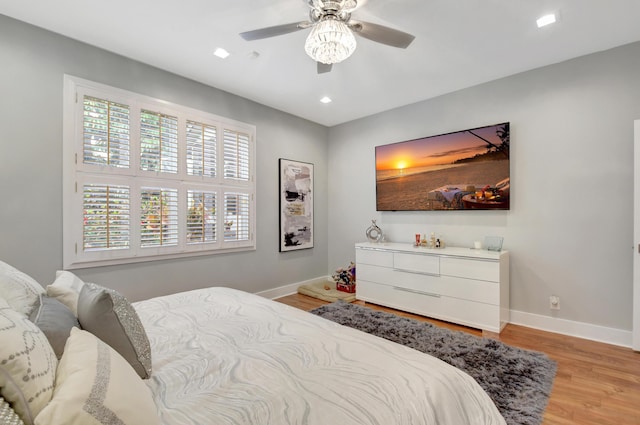 bedroom with ceiling fan and light wood-type flooring