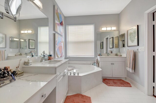 bathroom with vanity and tiled tub