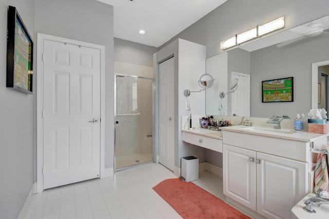 bathroom featuring vanity and a shower with shower door