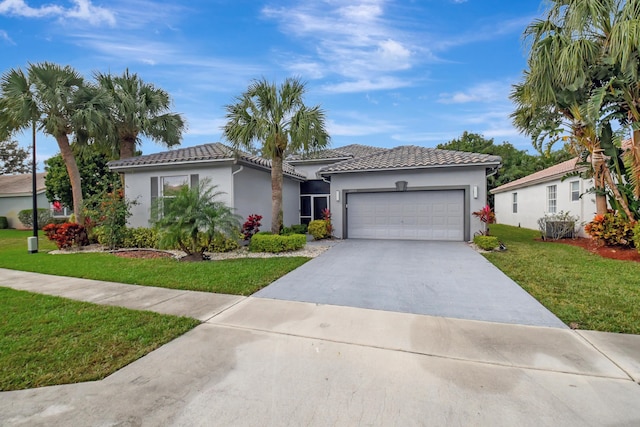 mediterranean / spanish home featuring a garage and a front lawn