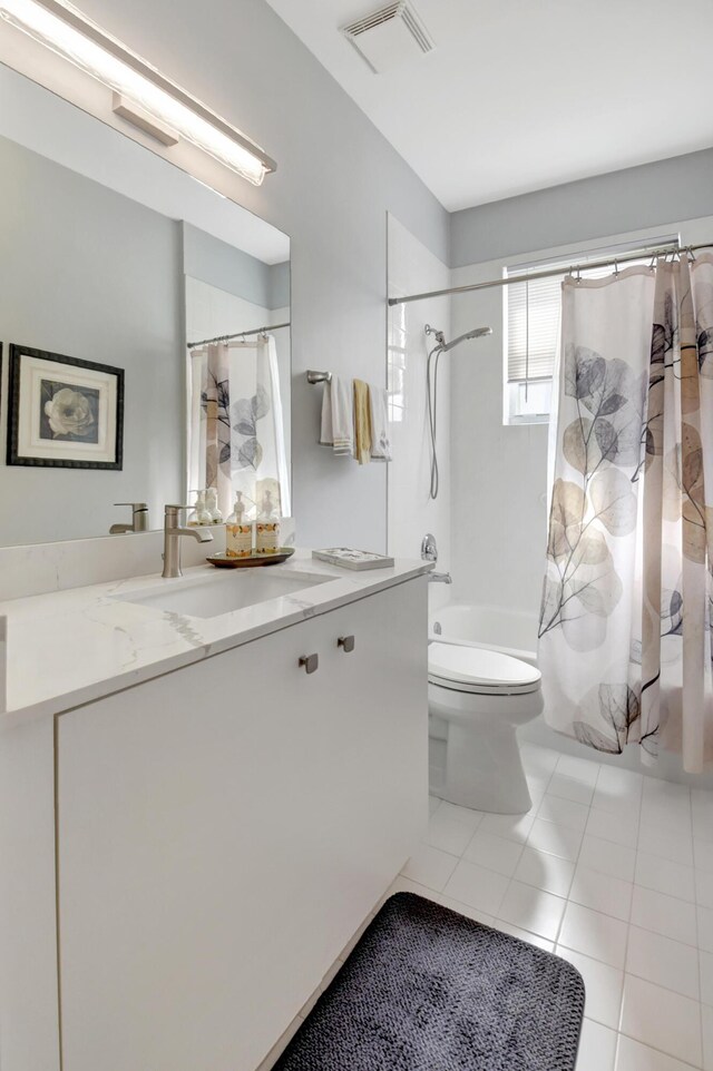 full bathroom featuring tile patterned floors, shower / bath combo, toilet, and vanity