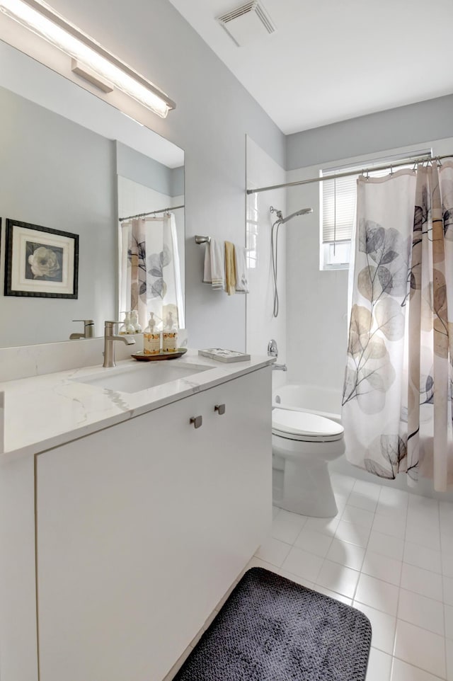 full bathroom featuring toilet, tile patterned floors, vanity, and shower / bathtub combination with curtain