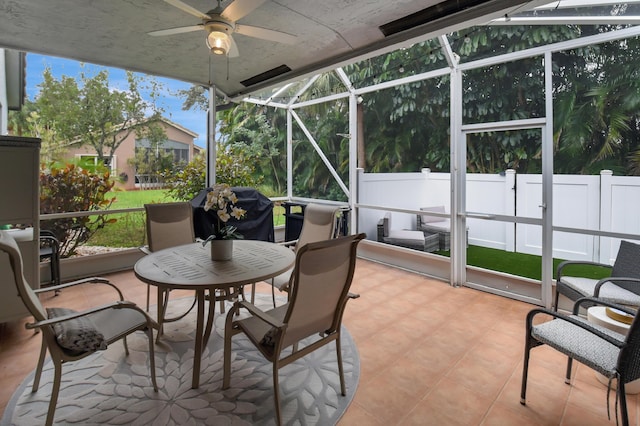 sunroom with ceiling fan and plenty of natural light