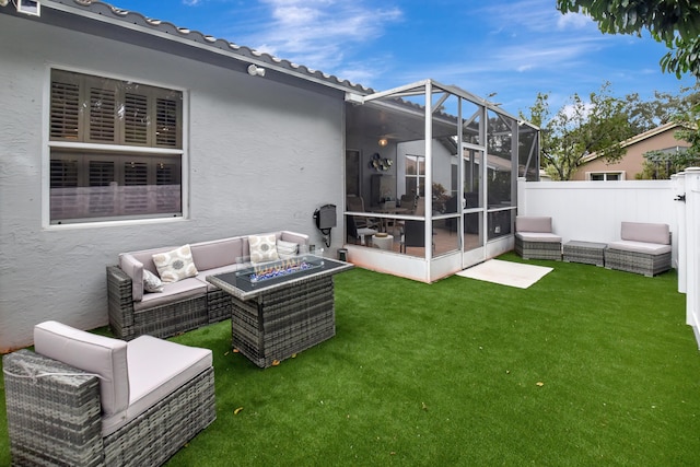 rear view of property with a yard, a lanai, and an outdoor living space with a fire pit