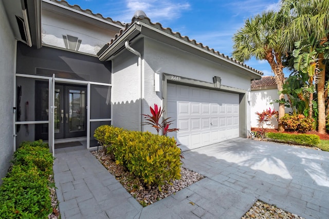 view of home's exterior featuring french doors and a garage