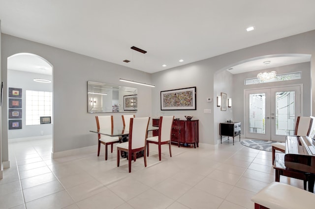 tiled dining area featuring french doors