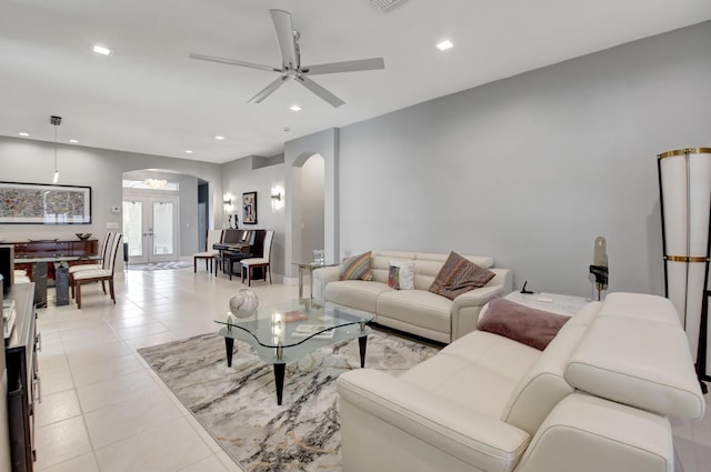 living room featuring french doors, ceiling fan, and light tile patterned floors