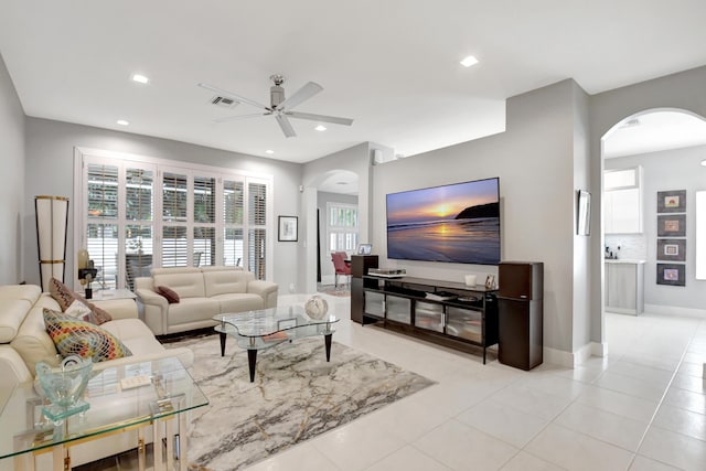 tiled living room featuring ceiling fan