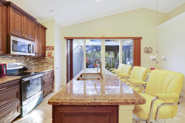 kitchen featuring appliances with stainless steel finishes, tasteful backsplash, lofted ceiling, and sink