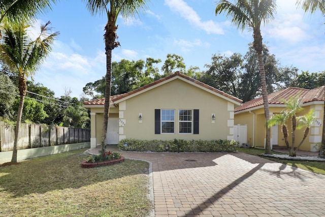 mediterranean / spanish-style house featuring a front yard