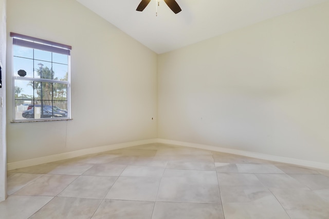 tiled empty room with ceiling fan and vaulted ceiling