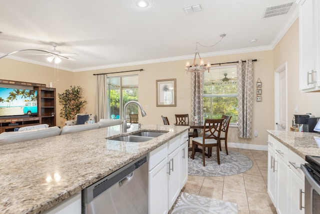 kitchen with sink, light tile patterned floors, light stone counters, white cabinets, and appliances with stainless steel finishes