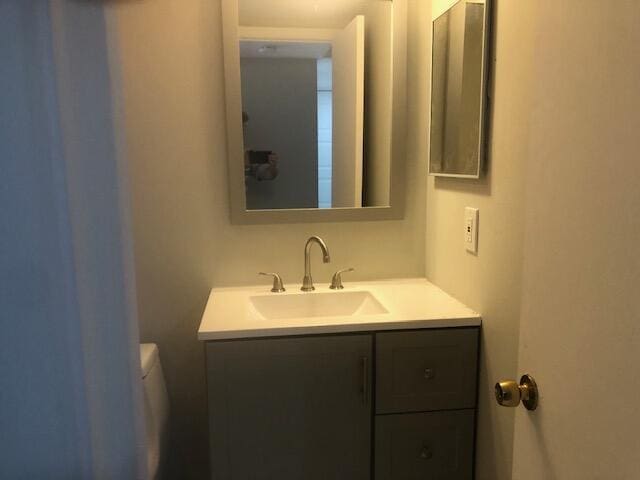 bathroom featuring vanity and toilet