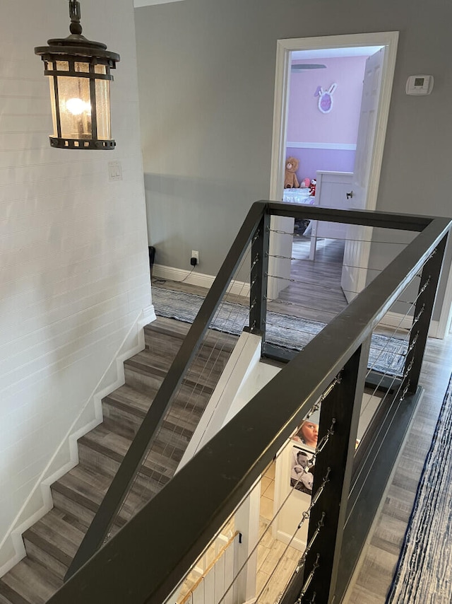 stairs featuring wood-type flooring