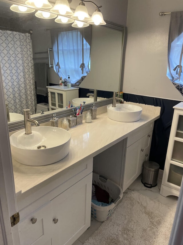 bathroom featuring tile patterned floors, vanity, and walk in shower