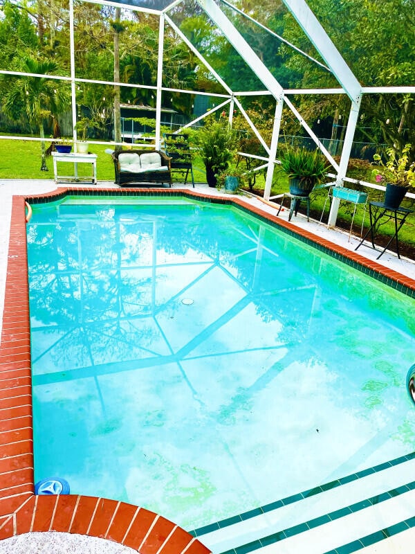 view of pool featuring a yard and a lanai