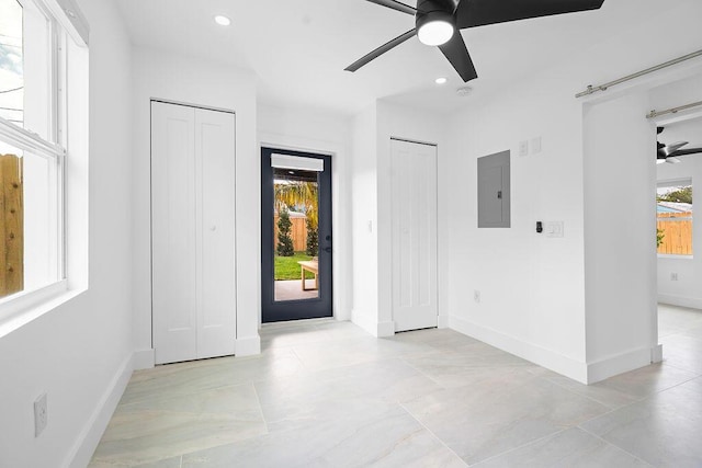 entryway with electric panel and ceiling fan