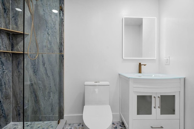 bathroom featuring a shower with door, vanity, and toilet