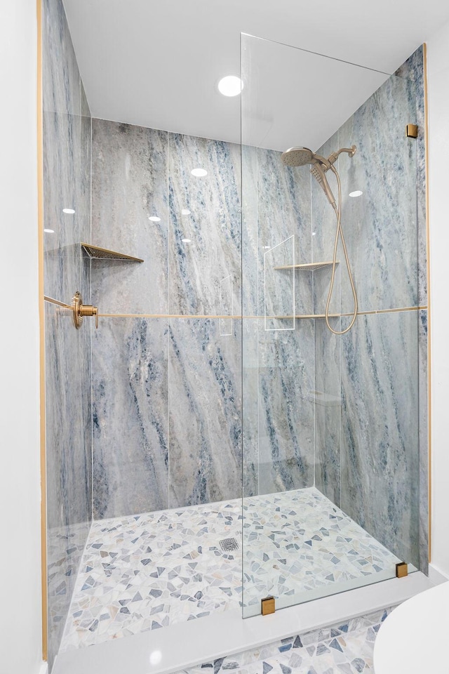 bathroom with tiled shower