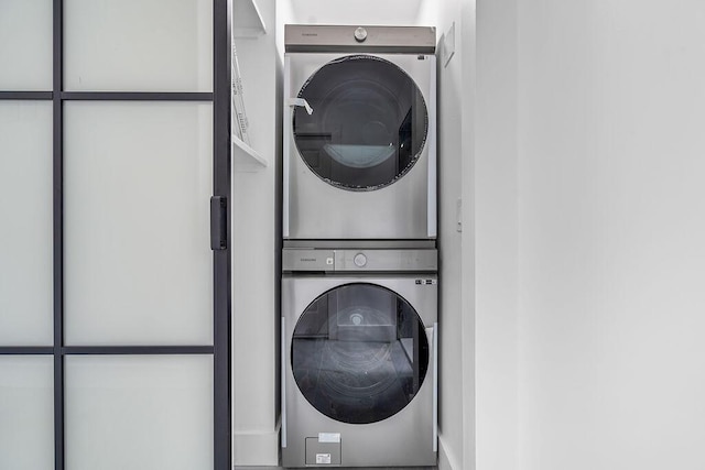 clothes washing area with stacked washer / drying machine