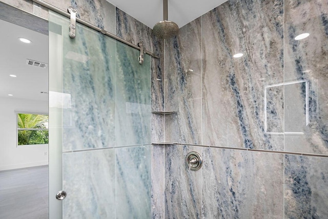 interior details featuring tiled shower