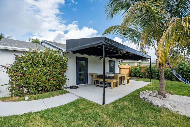 rear view of property featuring a yard and a patio