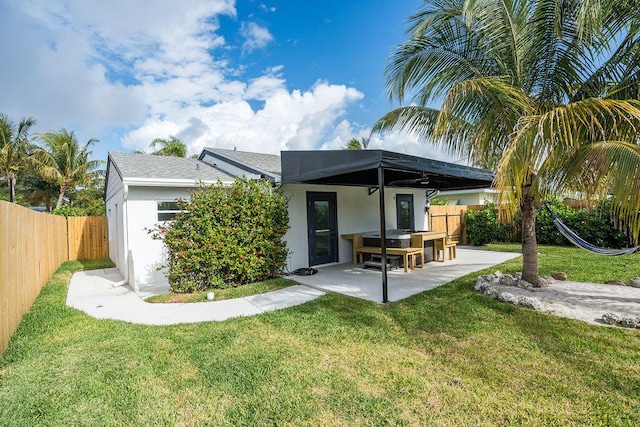 back of property with a patio and a lawn