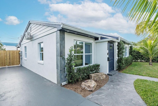 view of side of property with a lawn