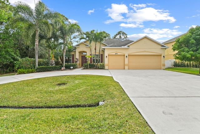 view of front of home featuring a front lawn and a garage