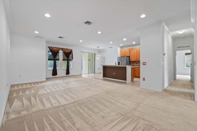 unfurnished living room featuring light colored carpet and ornamental molding