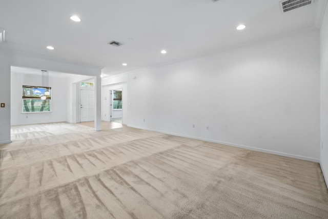 carpeted empty room with crown molding