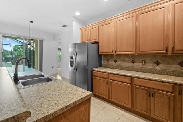 kitchen with decorative backsplash, stainless steel fridge, ornamental molding, sink, and light tile patterned flooring