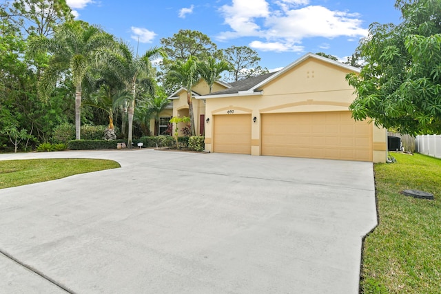 view of front of property with a front yard and a garage