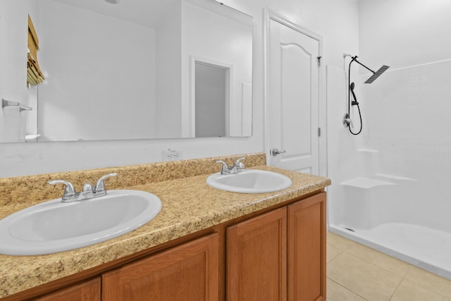 bathroom with tile patterned floors, vanity, and a shower