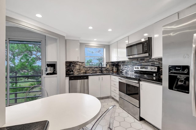 kitchen with white cabinets, plenty of natural light, and stainless steel appliances