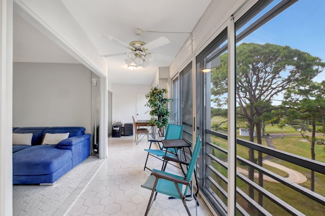 sunroom / solarium featuring ceiling fan