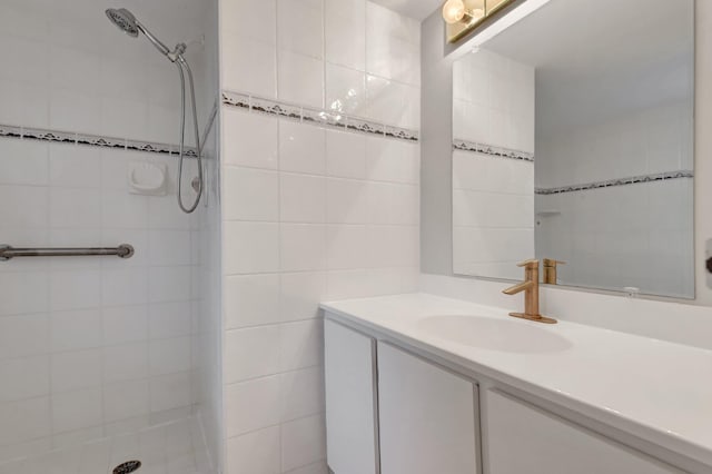 bathroom featuring vanity, tile walls, and tiled shower