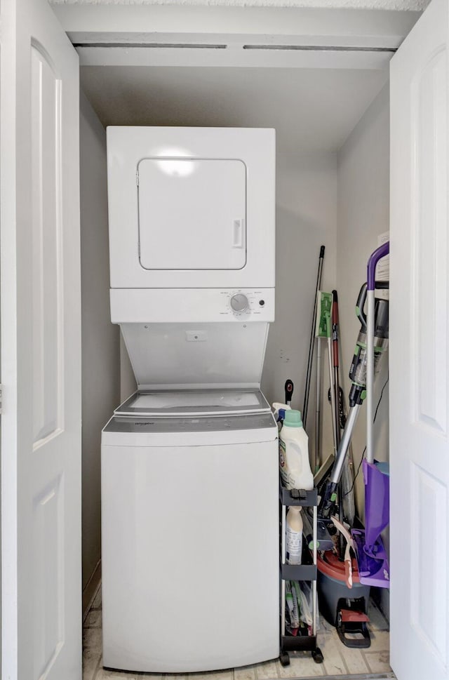 laundry area with stacked washing maching and dryer