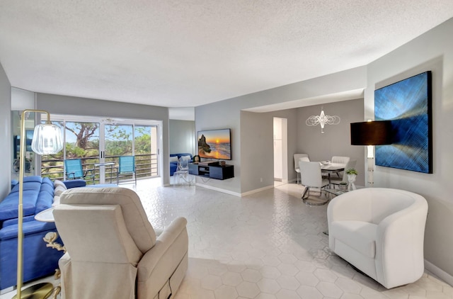 living room with a textured ceiling and a chandelier