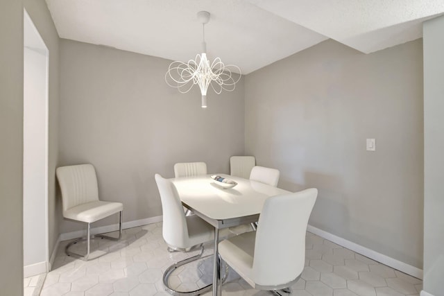 dining room featuring a chandelier and light tile patterned floors