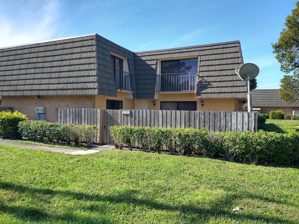 rear view of house with a lawn